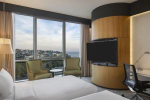 a hotel room with a bed and a flat screen tv at DoubleTree By Hilton Istanbul - Moda in Istanbul
