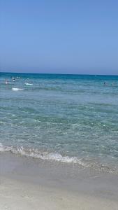 a group of people swimming in the ocean at Villino Sicaru' in Simius