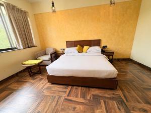 a bedroom with a bed and a chair at Jj Internatinals Group in Bhopal