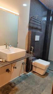 a bathroom with a sink and a toilet at The Mangrove Cove "200Mtrs from Beach" in Shādipur