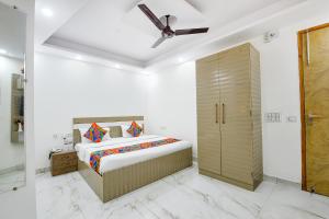 a bedroom with a bed and a ceiling fan at FabHotel Lotus Star in New Delhi +28 photos
