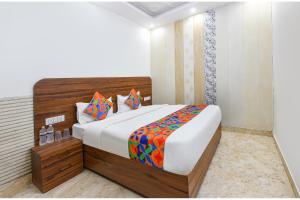 a bedroom with a large bed in a room at FabHotel Lotus Star in New Delhi