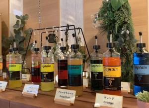 a group of bottles of alcohol sitting on a table at Super Hotel Midosujisen Esaka in Suita