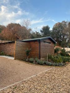 a brick building with a black roof at Nest-Dove's Nest in Howick