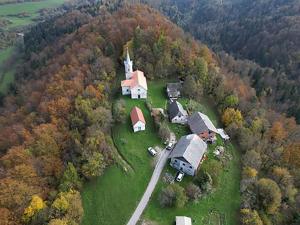 an aerial view of a house with a church at Apartment Volk Turjaški in Gabrovka