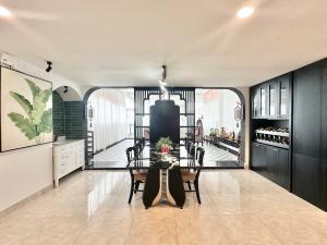 a dining room with a glass table and chairs at Phu Gia Hotel 13-15 Hoàng Quốc Việt in Ho Chi Minh City