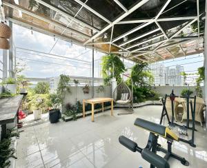 an indoor patio with a table and chairs and plants at Phu Gia Hotel 13-15 Hoàng Quốc Việt in Ho Chi Minh City