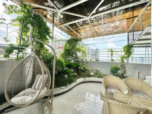 a patio with two chairs and a swimming pool at Phu Gia Hotel 13-15 Hoàng Quốc Việt in Ho Chi Minh City