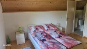a bedroom with a bed with a blanket on it at Eichberghaus in Aue
