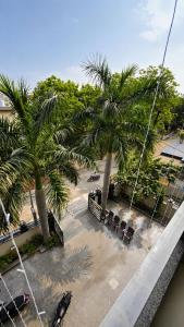 an aerial view of a parking lot with palm trees at The Grand Girivar Vrindavan # Lavis & Luxury Rooms # in Vrindāvan