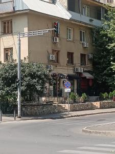 a traffic light on a street in front of a building at Cozy Family Apartment in Tbilisi City
