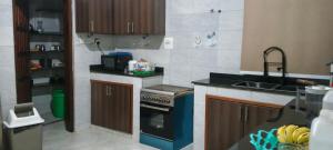 a kitchen with a sink and a stove top oven at Ashland Gardens in Vumba