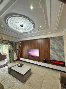 a large living room with a tv on a ceiling at Ashland Gardens in Vumba