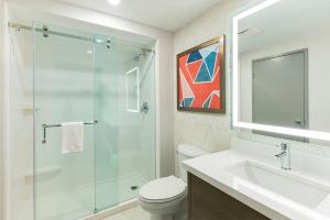 a bathroom with a shower and a toilet and a sink at Comfort Suites in London +18 photos