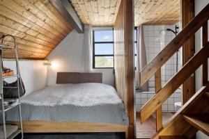 a small bedroom with a bed and a shower at 530-Lemvig-Lokkevej-59-D in Lemvig
