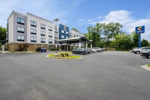 a hotel with cars parked in a parking lot at Comfort Suites New Bern near Cherry Point in New Bern