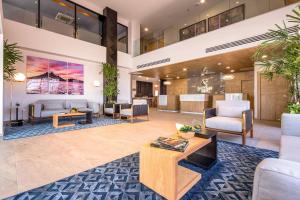 a lobby with couches and chairs and a table at Comfort Inn Hermosillo Aeropuerto in Hermosillo
