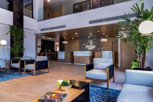 a lobby of a hotel with chairs and a table at Comfort Inn Hermosillo Aeropuerto in Hermosillo