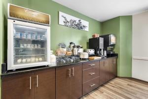 a kitchen with green walls and a counter with aasteryasteryasteryasteryasteryastery at Sleep Inn Nampa near Idaho Center in Nampa