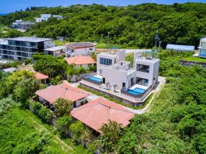 an aerial view of a large white house at Kandor Resort Okinawa in Nakijin