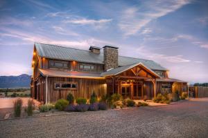 a large wooden house with a gambrel roof at Yellowstone Valley Lodge, an Ascend Collection Hotel in Pray