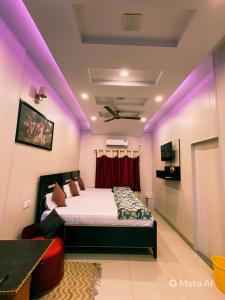 a bedroom with a bed with purple lighting at Golden River Homestay in Varanasi