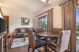 a living room with a table and chairs and a couch at Yellowstone Valley Lodge, an Ascend Collection Hotel in Pray