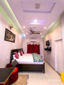 a bedroom with a large bed with a red curtain at Golden River Homestay in Varanasi +25 photos