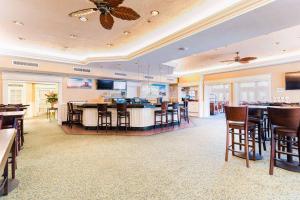 a large room with tables and chairs and a restaurant at Radisson Resort at the Port in Cape Canaveral