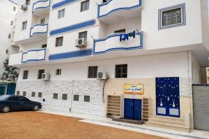 a building with a car parked in front of it at Alaraby 2 in Az Zaytīyah