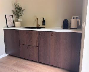 a kitchen with a sink and a counter top at Maison Cromvoirt in Cromvoirt