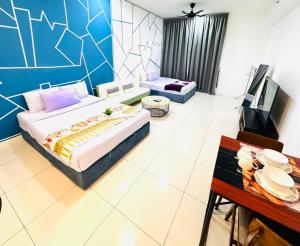 a bedroom with a large bed and a tv in it at Chamber Haven KLCC in Kuala Lumpur