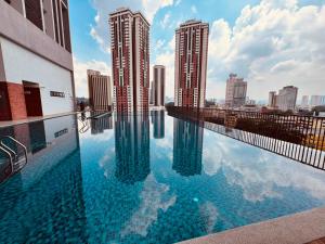 a swimming pool with a view of a city at Chamber Haven KLCC in Kuala Lumpur