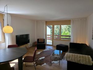 a living room with a couch and a table at Haus Belstar B in Naters
