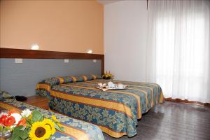 Postel nebo postele na pokoji v ubytování Hotel Bettina