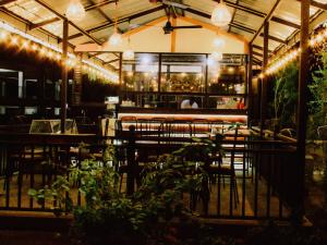 a restaurant with chairs and a bar with lights at Saranga Holiday Inn in Wellawaya