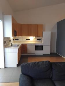a kitchen with white appliances and a couch at Gästrum in Halmstad