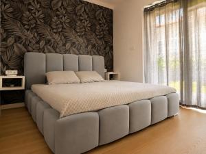 a large bed in a bedroom with a wall at Royal Rest Apartments Karlovac-Luxury, Central Location & Free Parking in Karlovac +185 photos