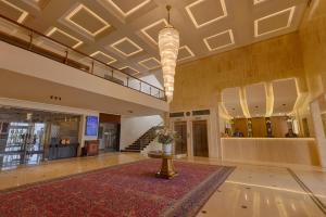 a large lobby with a table and a staircase at Riviera Hotel and Beach Lounge, Beirut in Beirut