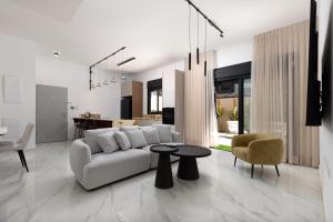 a living room with a white couch and a table at Katalina Luxury Apartment Eilat in Eilat