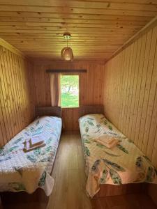 a small room with two beds in a cabin at Kaghu in Martvili
