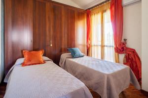 a bedroom with two beds and a window at Villa Tiffany in Marsala +17 photos
