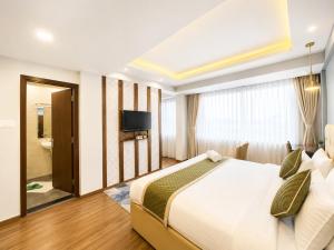 a hotel room with a bed and a television at Hotel Durga Palace in Sonepur