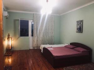 a bedroom with a bed and a window at Wild Caspian coast in Aşağıoba