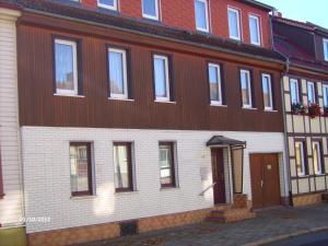 a large brown and white building with a door at Ferienhaus Benneckenstein in Benneckenstein