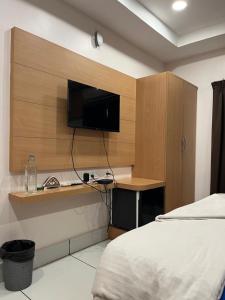 a bedroom with a bed and a desk with a television at Adhunik palace in Keonjhargarh