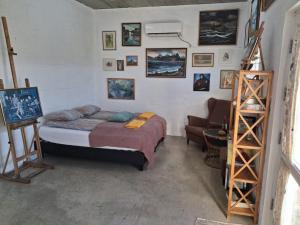 a bedroom with a bed and pictures on the wall at Snaefell Apartments in Hellissandur
