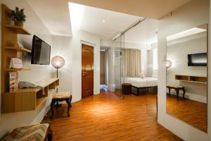 a hotel room with a bathroom and a bedroom at MySpace Hotel @BGC in Manila
