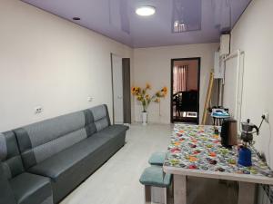 a living room with a couch and a table at Asian Guest House in Bishkek