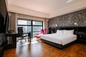 a bedroom with a bed and a desk and a computer at Hotel Maya Kuala Lumpur City Centre in Kuala Lumpur